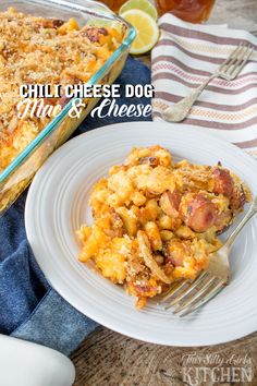 a white plate topped with macaroni and cheese casserole next to a fork