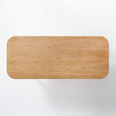 a wooden cutting board sitting on top of a white wall