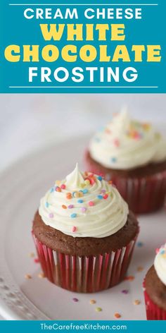 three chocolate cupcakes with white frosting and sprinkles on a plate