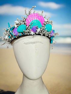 Pearls and Shells Mermaid Crown Dive into the enchanting world of mermaids with our Hand Made, Hand-painted Pearls and Shells Mermaid Crown by The Head Mistress. Transform into a majestic sea princess with this exquisite crown adorned with hand-painted shells and shimmering glitter finish. Key Features: Perfect for Mermaid Photoshoots: Capture stunning mermaid moments with this crown. Adjustable Metal Base: Ensures a comfortable fit and comes with loops for secure fastening using bobby pins. Designed for Ages 6 and Up: Ideal for young mermaid princesses ready to make a splash. Indulge in the magic of the sea and elevate your mermaid look with our Pearls and Shells Mermaid Crown. Purchase two crowns and enjoy free shipping to complete your transformation into a finned diva of the sea! Mermaid Look, Sea Princess, Mermaid Crown, Fabric Photography, Painted Shells, Mermaid Princess, Photography Backdrops, Metal Base, Bobby Pins