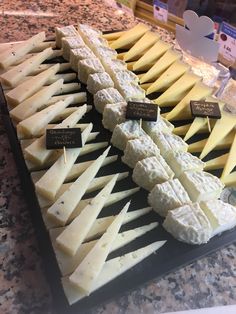 several different types of cheese on display in a store