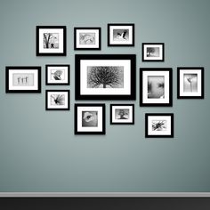 black and white photo frames arranged on the wall