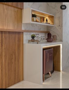 a modern kitchen with marble counter tops and wooden shelves on the wall, along with an open cabinet door