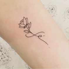 a woman's arm with a small tattoo on it