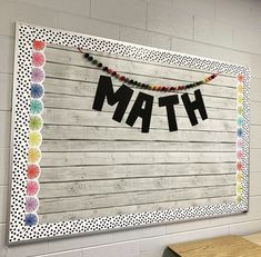 a bulletin board with the word math hanging on it's side in front of a wall