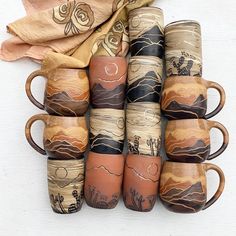 six coffee mugs are stacked on top of each other in different colors and designs