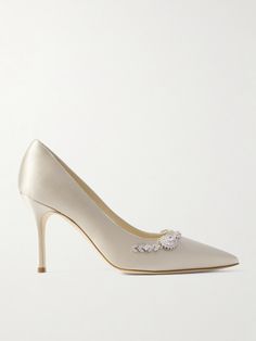 Timeless designs and exquisite details make Manolo Blahnik's pumps extra special. This  'Lamikpump' pair has been crafted in Italy from smooth satin with a rich luster and embellished with an intricately arranged band of glinting crystals. The low-cut vamp, point-toe profile and slender stiletto heels give the illusion of taller proportions. Luxury Court Shoes With 4-inch Heel For Wedding, Luxury Embellished Heels For Reception, Luxury Wedding Court Shoes With 4-inch Heel, Elegant Embellished Heels For Events, Elegant Embellished Heels For Event, Elegant Evening Court Shoes, Luxury Almond Toe Court Shoes For Wedding, Elegant Embellished Pointed Toe Heels, Luxury Heels For Reception