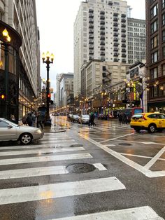 a city street with cars and people walking on it