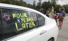 four years later written on the side of a white car with girls standing behind it