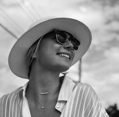 a woman wearing sunglasses and a hat