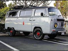 an old vw bus parked in a parking lot