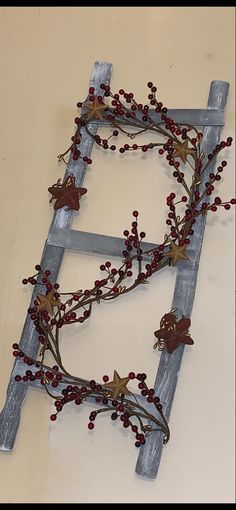 a ladder decorated with red berries and leaves