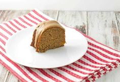 a piece of cake sitting on top of a white plate next to a red and white napkin