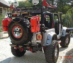 an off road vehicle parked in front of a house