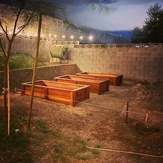 several wooden benches sitting on top of a dirt field