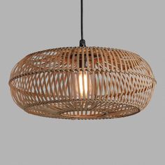 a wooden light hanging from a ceiling fixture with an oval design on the top and bottom