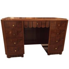 a wooden desk with several drawers on each side and one drawer open at the top