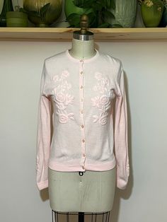 "Vintage 50s pink knit cardigan sweater w/ floral embroidery. Great colors/shape. Nice vintage condition with wear thats consistent with age. Please see photos for reference.   S/M  Shoulder 16\" Pit to pit 18\" Length 22\" Sleeve 23\"" Pink Floral Embroidery Cardigan For Spring, Winter Pink Cardigan With Floral Embroidery, Pink Floral Embroidered Winter Cardigan, Pink Floral Embroidery Cardigan For Winter, Vintage Pink Winter Cardigan, Fitted Vintage Pink Cardigan, Pink Vintage Winter Cardigan, Pink Embroidered Fitted Cardigan, Fitted Embroidered Pink Cardigan