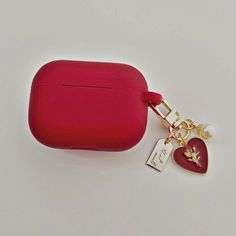 a red case with a heart charm attached to it