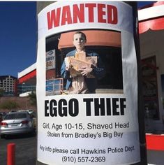 a sign posted on a pole in front of a gas station advertising egg thief, taken from bradley's big buy