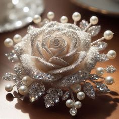 a close up of a flower on a table with pearls and other things in the background