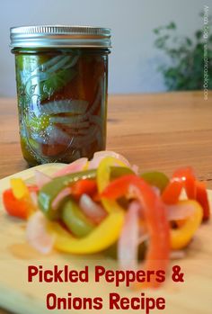 pickled peppers and onions recipe on a cutting board next to a jar of pickled peppers