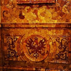 an ornately designed bathroom with gold and brown tiles