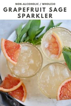 three glasses filled with ice and garnished grapefruits on a plate