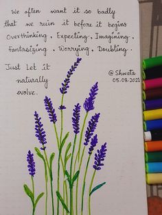 a handwritten note with purple flowers and green stems on it next to colored crayons