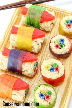 sushi rolls are made with rice and vegetables on a wooden tray, ready to be eaten