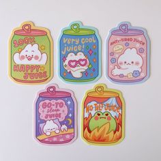 four stickers with cartoon characters on them in different colors and shapes, including hello kitty