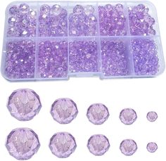 purple crystal beads are in a plastic container and on the table is an assortment of different sizes