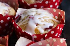 a muffin with white icing and red polka dot paper wrappers