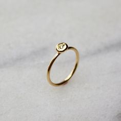 Gold Pearl Ring - Pearl Diamond Ring - Dainty Diamond Ring - Keshi Pearl Ring This dainty diamond solitaire ring is cast from a natural keshi pearl: imperfect, and completely at ease with itself. Wear it as a reminder that you are perfect just as you are. STYLING TIPS + This dainty ring stacks really well with other bands + Wear it on your pinky like a little promise to yourself DETAILS + Pearl is 4mm by 5mm  + Conflict-free 1.3mm diamond is 0.01ct  + Ring shank: 1mm + 14k yellow gold + Made to Minimalist Initial Ring With Birthstone, Minimalist Promise Dome Ring, Minimalist Birthstone Initial Ring, Pearl Diamond Ring, Pebble Ring, Ring Stacks, Chunky Silver Rings, Dainty Diamond Ring, Ring Pearl