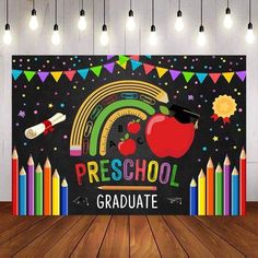 a blackboard with an apple and rainbows on it that says preschool graduate