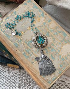 Charlotte 7- This 25"inch pendant necklace is perfect for layering or adding French flair to your everyday favorites! Antiqued silver stamped Marie Antoinette pendant looks fabulous with a repurposed, one of a kind, vintage earring as a centerpiece. The necklace chain is a silver and aqua cut glass rosary chain and the clasp is a silver lobster claw. Vintage Rhinestone Earrings, Vintage Earring, Rosary Chain, Marie Antoinette, Rhinestone Earrings, Vintage Rhinestone, Necklace Chain, Cut Glass, Rosary