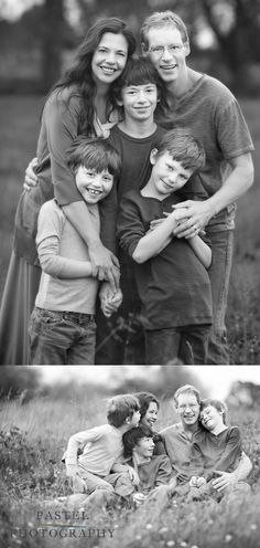 a family is posing for a black and white photo in the grass with their arms around each other