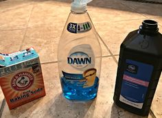 three different types of bottled water on the ground