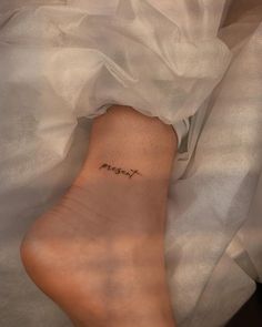 a person with a small tattoo on their foot that says, i am not here