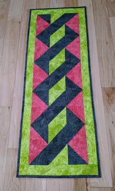 a quilted table runner is on the floor