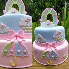 two cakes decorated with rainbows, clouds and umbrellas on top of each other