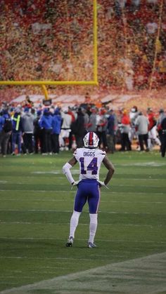 a football player standing on top of a field