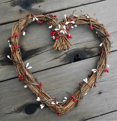 a heart shaped wreath with red and white flowers