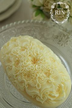 a close up of a piece of cake on a plate with flowers in the background