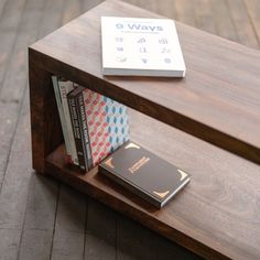 a wooden bench with books on top of it