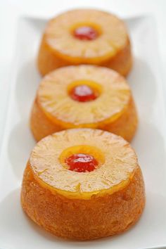 three pineapple upside down cakes on a white plate