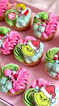 the grinch cupcakes are decorated with green and pink frosting