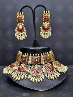 AvighnaGems Indian Ethnic Pachi Ahemdabadi Kundan 22 Carat Gold Plated Necklace Set * This Set Is made up with High Quality Pachi Kundan * 22 Carat Gold Plating Is used * High Quality Beads Are used * Set includes Necklace, Earrings  Care Instruction: Don't use perfumes and deodorants directly on the product About us: Kundanjewelsbyshiv is a pioneer firm in the semi-precious jewellery business in the city of Pune. We offer a wide variety of products from heavy necklaces to hath fool and gorgeous