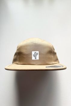 Elmntry - Khaki/White, Cactus 5 Panel Camp Hat The "Cactus" 5 Panel Camp hat is made in a low profile, classic fit with an adjustable clip closure. 100% cotton with woven label sewn on by our own hands in the USA. One size fits all, unisex fit. Imported. Please note: though I choose colors intentionally and precisely when creating my products, colors may slightly vary due to photographic lighting sources / image processing or your screen / monitor settings. Adjustable Beige Snapback Hat For Outdoor, Beige Snapback Hat For Outdoor, Casual 5-panel Outdoor Hat, Beige Snapback Hat With Flat Bill For Outdoor, Everyday Summer Trucker Hat With Flat Bill, Casual Flat Bill Hats For Outdoors, Casual Flat Bill Hats For Outdoor, Casual Beige Flat Bill Hat, Adjustable Flat Brim Beige Dad Hat