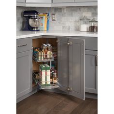 an open cabinet in the corner of a kitchen with spices and condiments on it